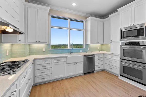 a kitchen with stainless steel appliances granite countertop a stove and a sink