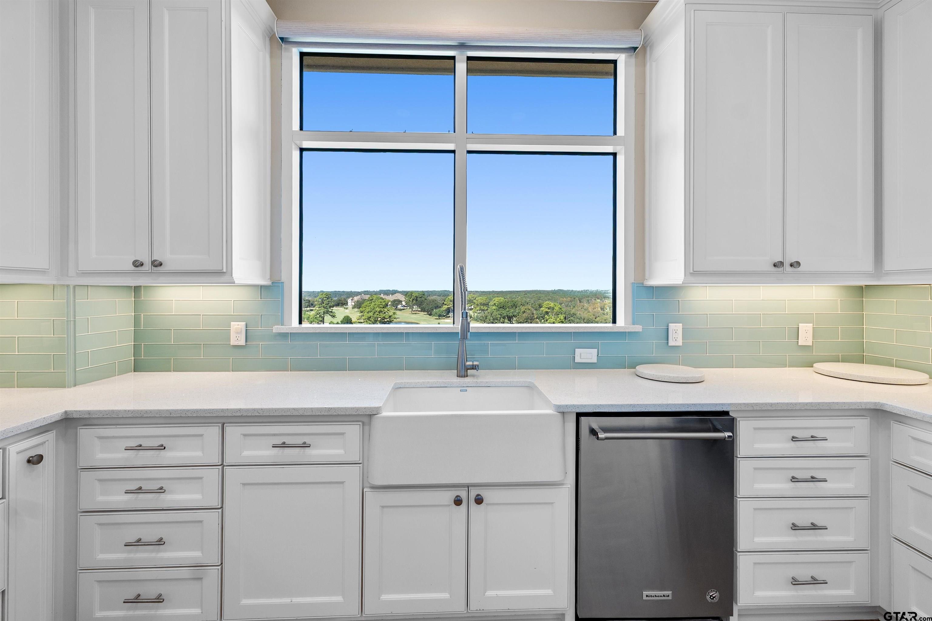 2801 Wexford Drive Tyler, TX 75709 - Photo 22 of 31 a kitchen with cabinets appliances a sink and a window