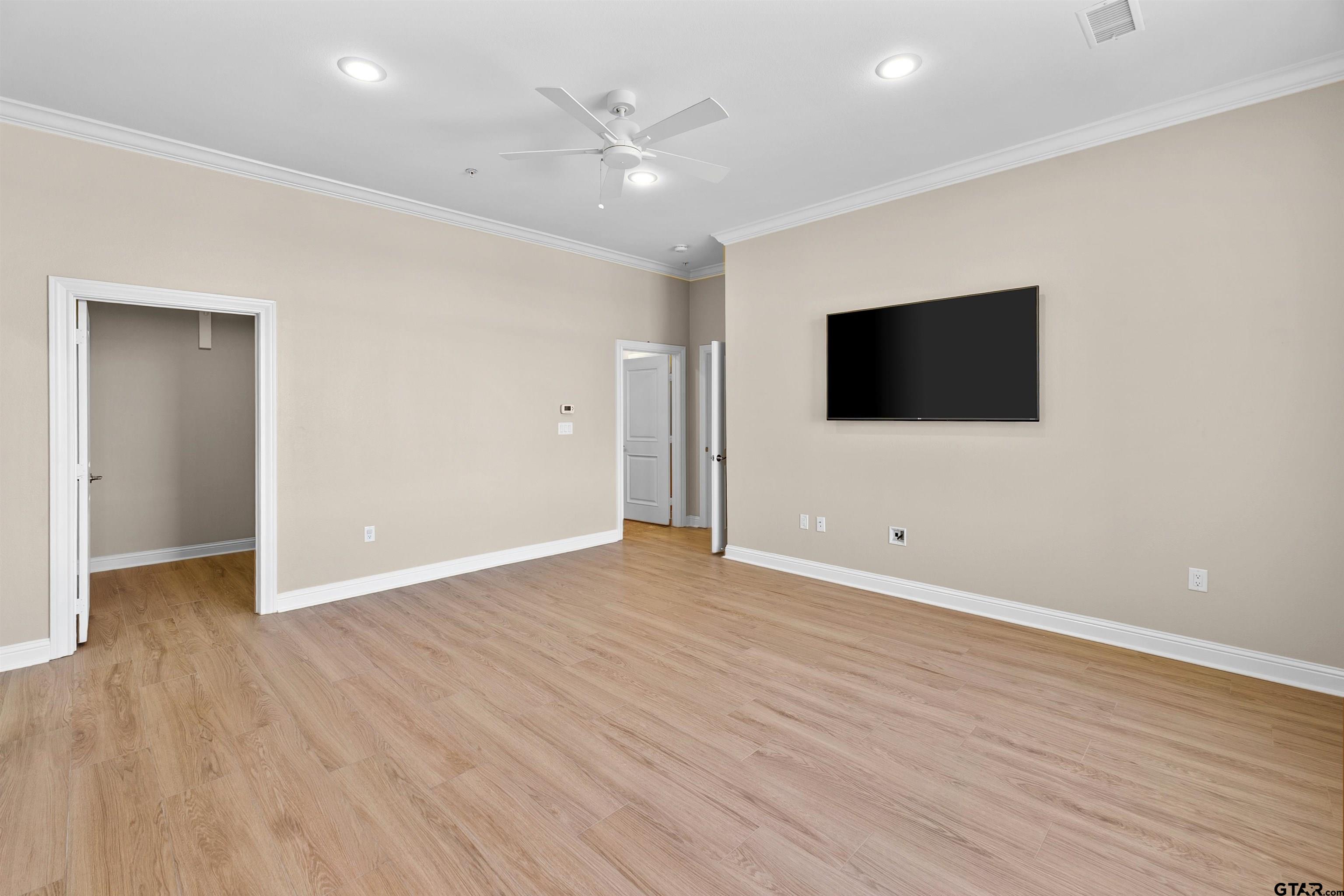 2801 Wexford Drive Tyler, TX 75709 - Photo 27 of 31 an empty room with wooden floor and windows