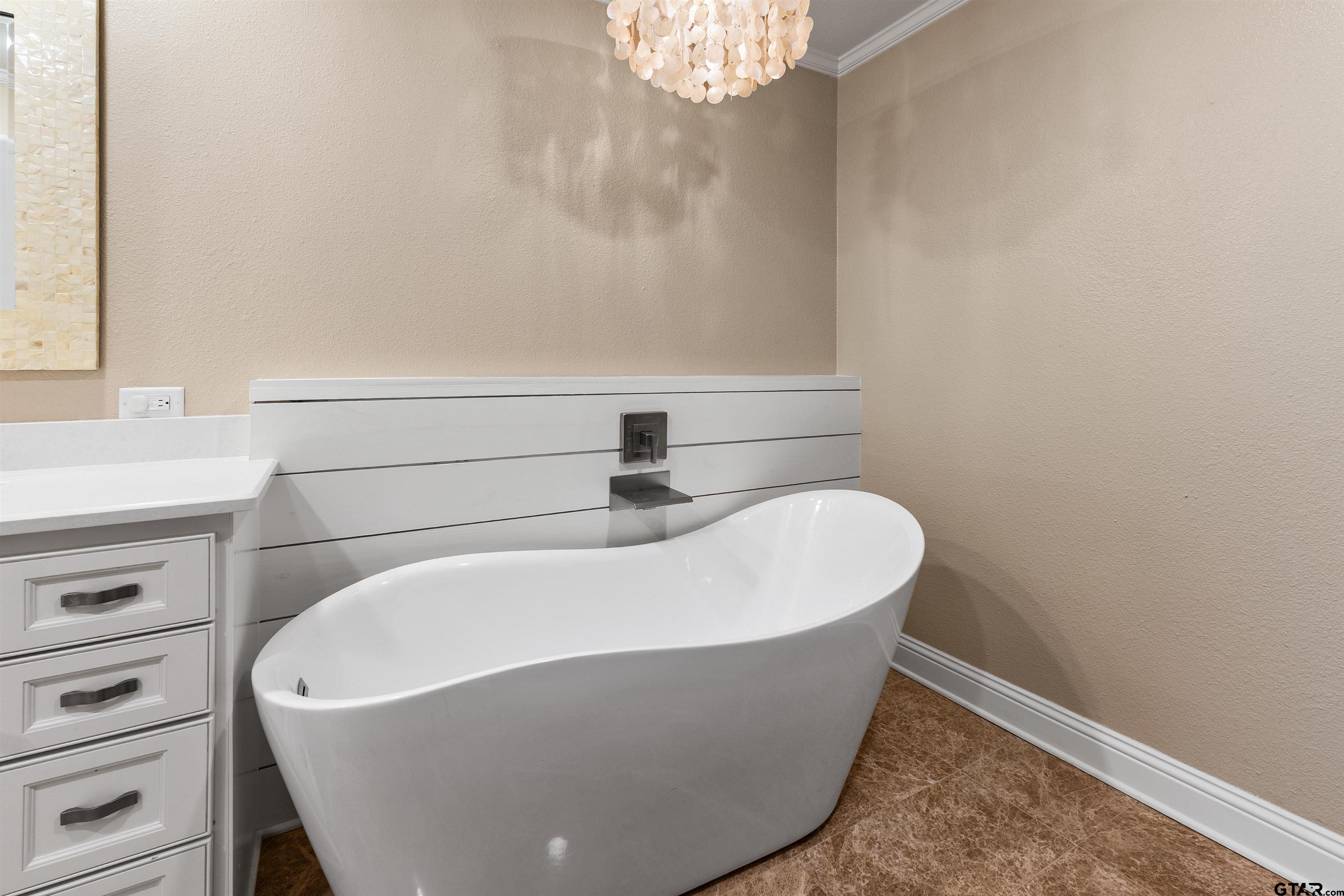 2801 Wexford Drive Tyler, TX 75709 - Photo 29 of 31 a white bath tub sitting in a bathroom