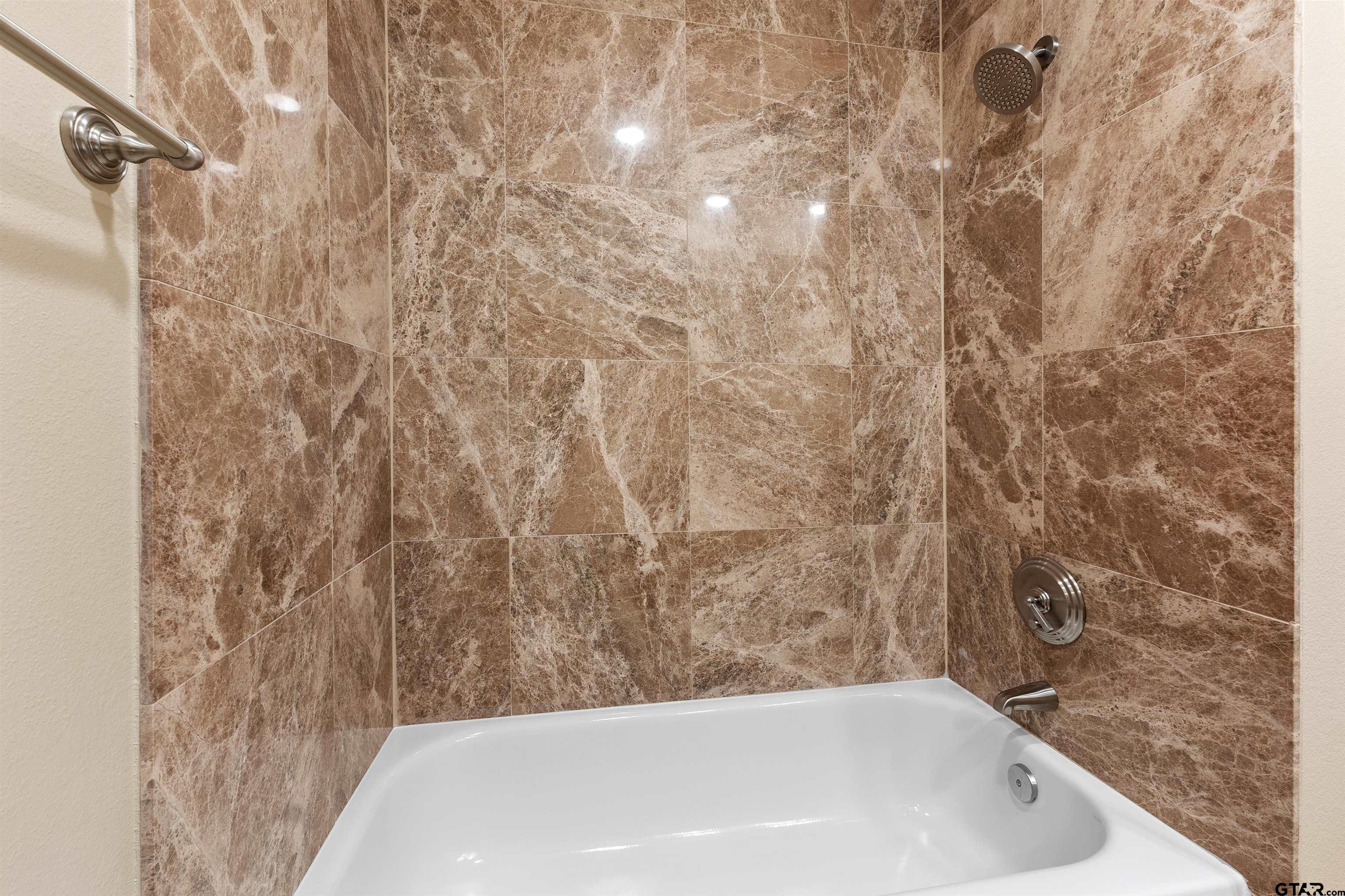 2801 Wexford Drive Tyler, TX 75709 - Photo 3 of 31 a bathroom with a bathtub