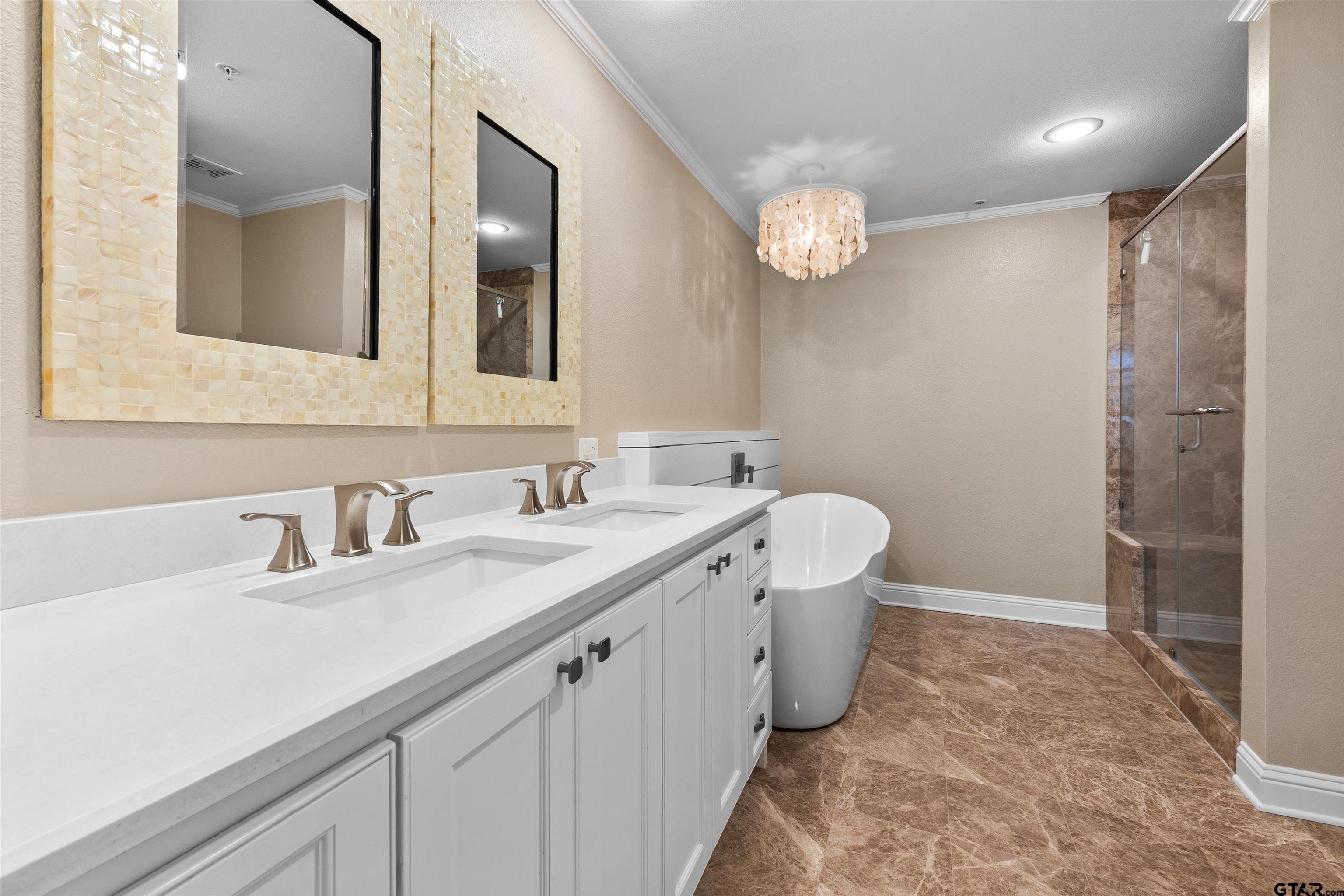 2801 Wexford Drive Tyler, TX 75709 - Photo 8 of 31 a spacious bathroom with a double vanity sink mirror and a toilet