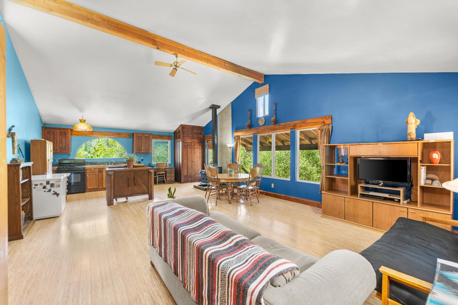 23650 Tundra Road Auburn, CA 95602 - Photo 12 of 45 a living room with furniture a flat screen tv and a large window
