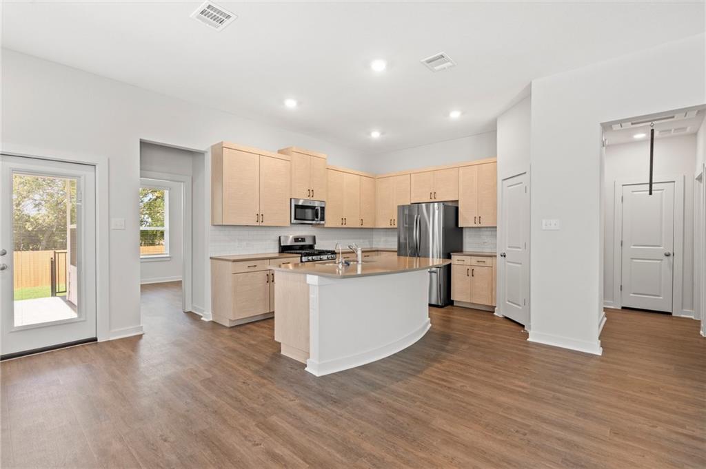 1012 Paddock Lane Georgetown, TX 78626 - Photo 1 of 15 Culinary delights await in this bright, open-concept kitchen with a curved island and direct outdoor access.