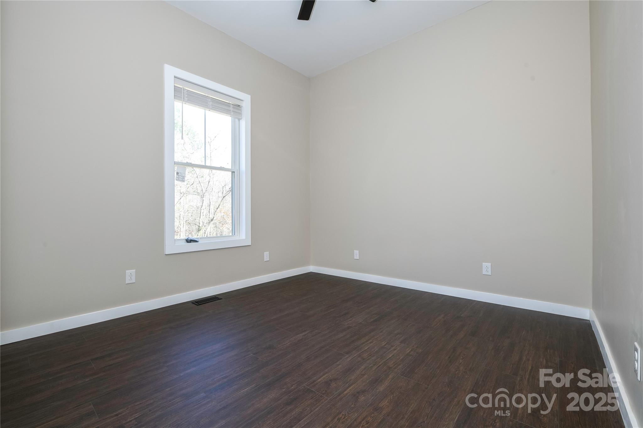 2162 Watson Road Lenoir, NC 28645 - Photo 22 of 23 an empty room with wooden floor and windows