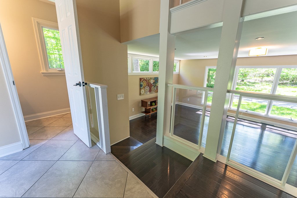 220 Hibiscus Drive Rochester, NY 14618 - Photo 19 of 50 Just a few steps down from the dining room, the recreation room opens, wrapped in windows that blur the line between indoors and out.
