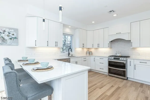 a kitchen with a stove a sink and a refrigerator