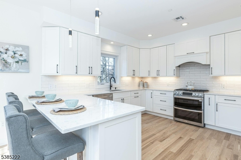 484 4th Avenue, Unit 9 Garwood, NJ 07027 - Photo 11 of 28 a kitchen with a stove a sink and a refrigerator