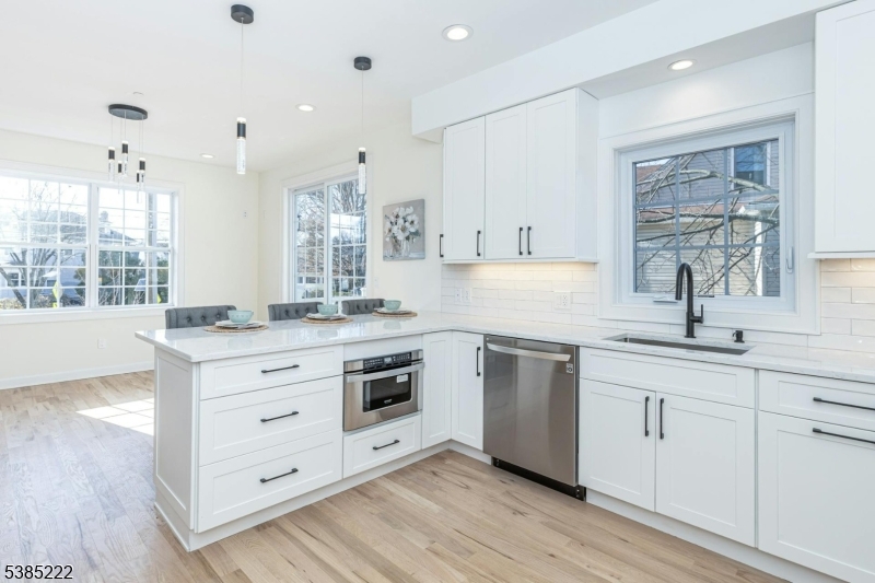 484 4th Avenue, Unit 9 Garwood, NJ 07027 - Photo 14 of 28 a kitchen with granite countertop white cabinets and white appliances