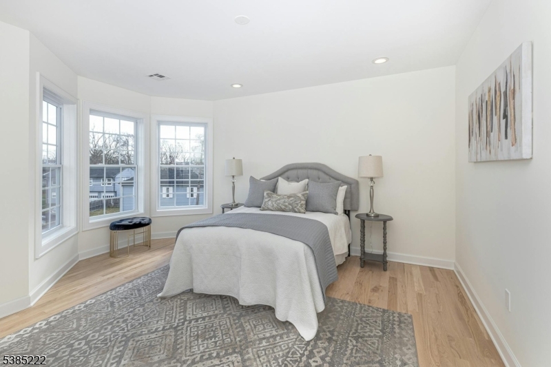 484 4th Avenue, Unit 9 Garwood, NJ 07027 - Photo 16 of 28 a bedroom with a bed and glass window