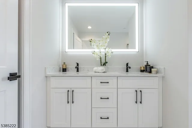 a bathroom with a sink vanity and mirror