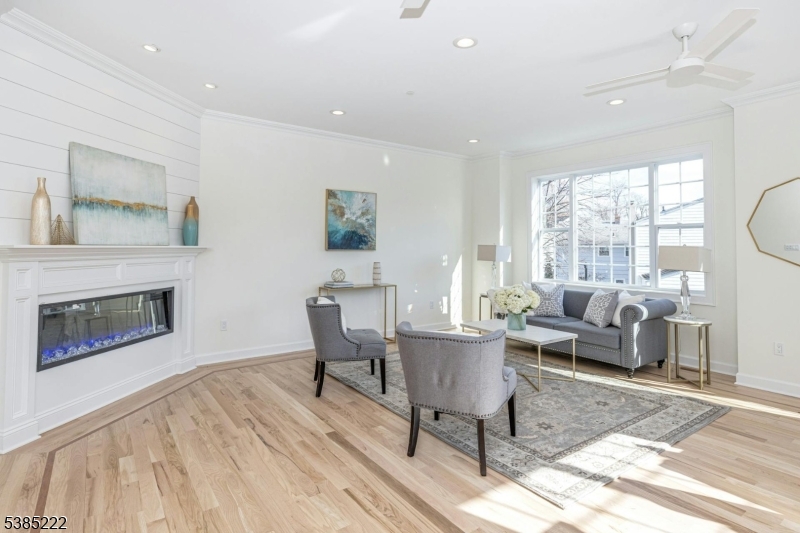 484 4th Avenue, Unit 9 Garwood, NJ 07027 - Photo 3 of 28 a living room with furniture a fireplace and a table