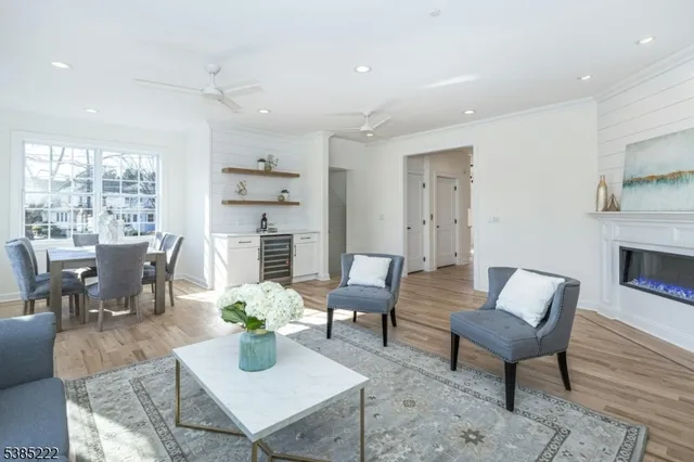 a living room with furniture fireplace and a table