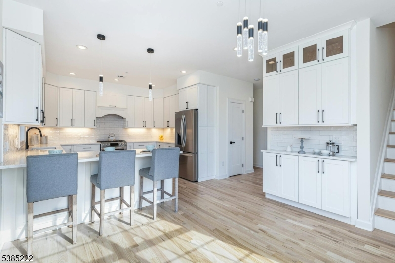 484 4th Avenue, Unit 9 Garwood, NJ 07027 - Photo 9 of 28 a kitchen with kitchen island granite countertop a sink cabinets and stainless steel appliances