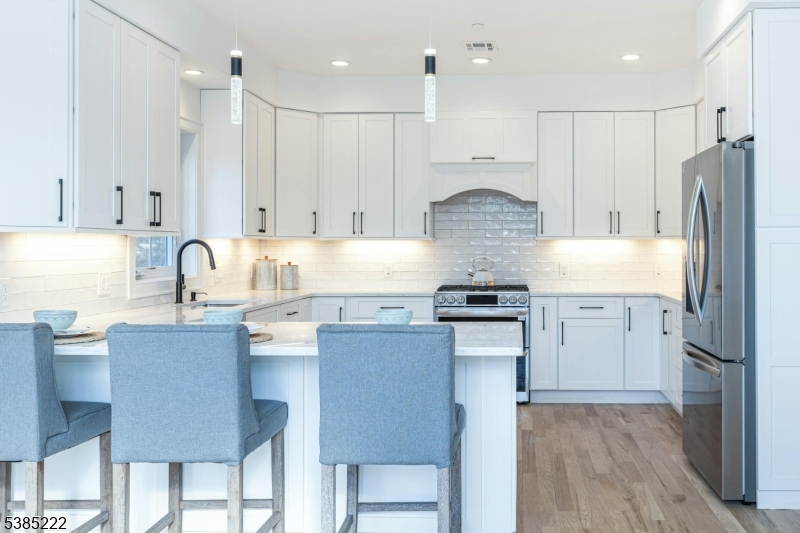 484 4th Avenue, Unit 9 Garwood, NJ 07027 - Photo 10 of 28 a kitchen with stainless steel appliances granite countertop a stove refrigerator sink and cabinets