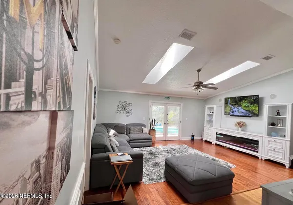 a living room with furniture and a flat screen tv