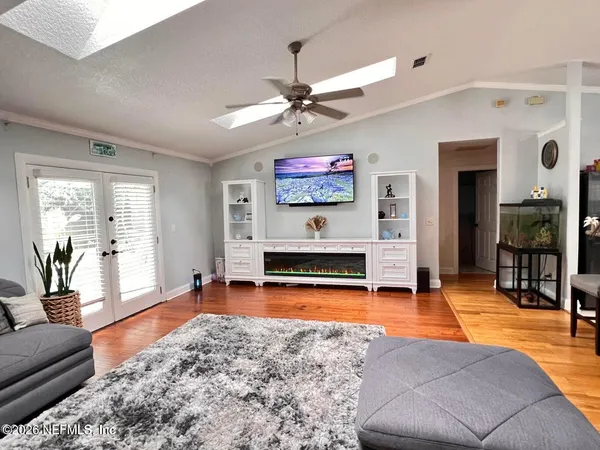 a living room with furniture pool table and a large window