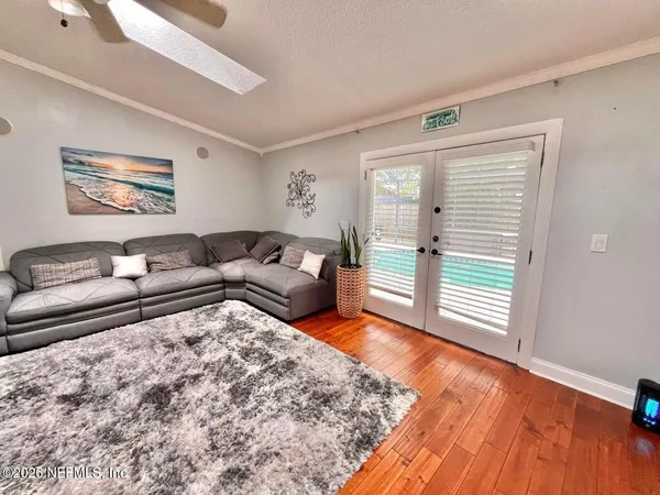 a living room with furniture and a wooden floor