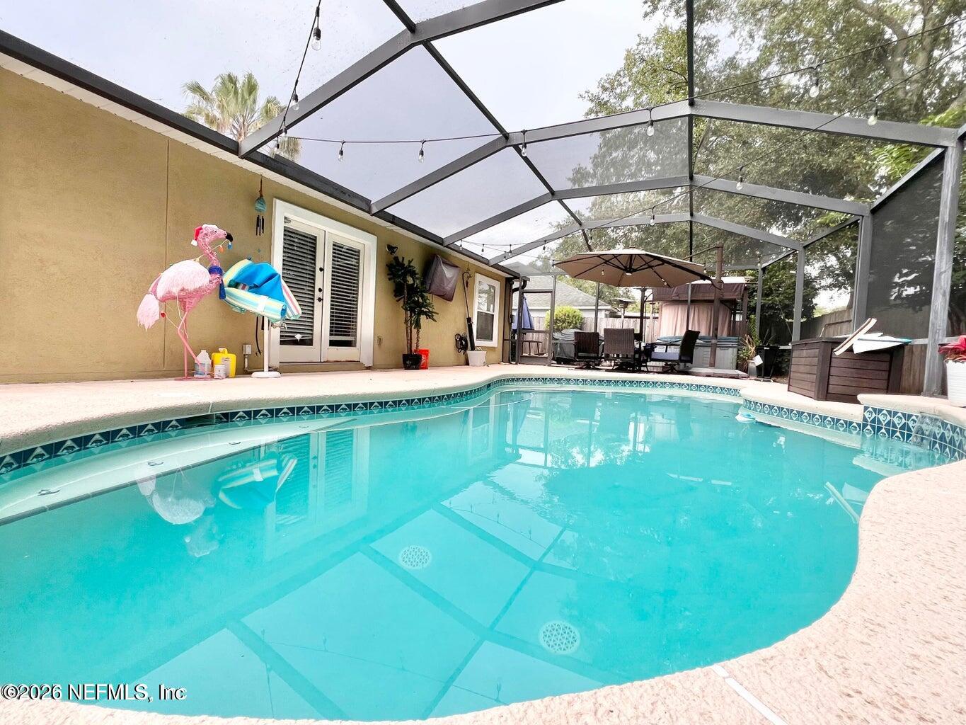 3419 Bristol Bridge Road Orange Park, FL 32073 - Photo 2 of 36 a swimming pool with outdoor seating and yard