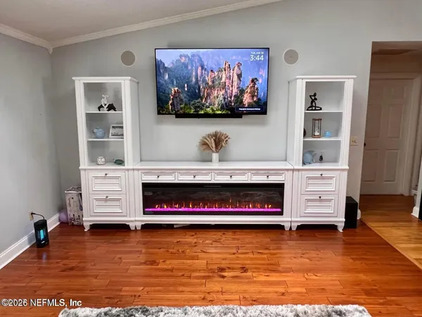 a living room with fireplace furniture and a flat screen tv