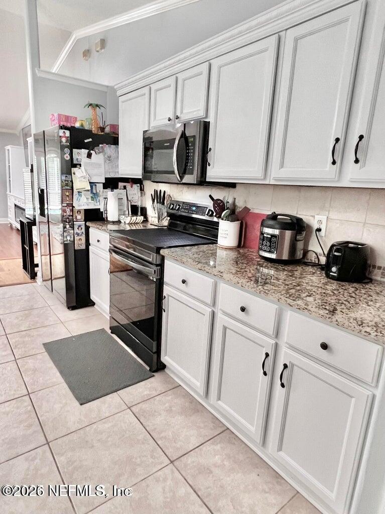 3419 Bristol Bridge Road Orange Park, FL 32073 - Photo 8 of 36 a kitchen with stainless steel appliances granite countertop a refrigerator sink and cabinets
