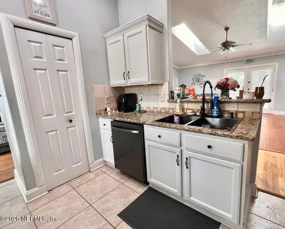a kitchen with white cabinets and white appliances