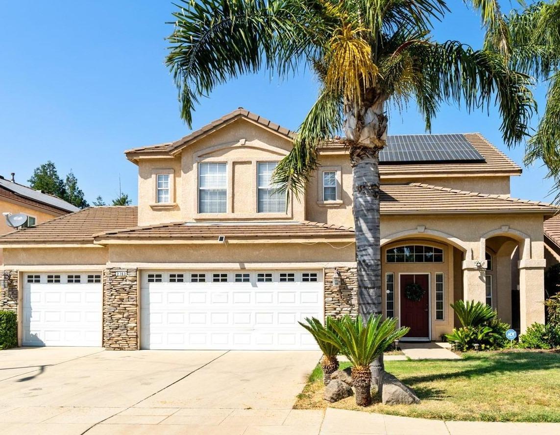 2763 Pico Avenue Clovis, CA 93611 - Photo 1 of 27 a view of a white house with a small yard and palm trees