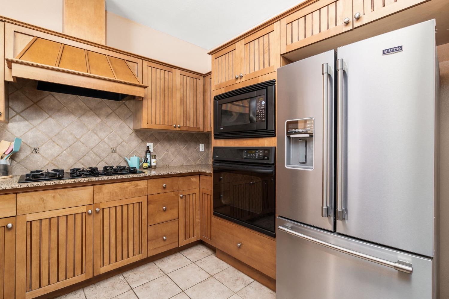2763 Pico Avenue Clovis, CA 93611 - Photo 12 of 27 a kitchen with stainless steel appliances granite countertop a refrigerator and a stove top oven