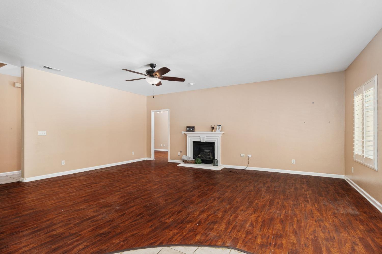 2763 Pico Avenue Clovis, CA 93611 - Photo 14 of 27 a view of an empty room with a fireplace and wooden floor