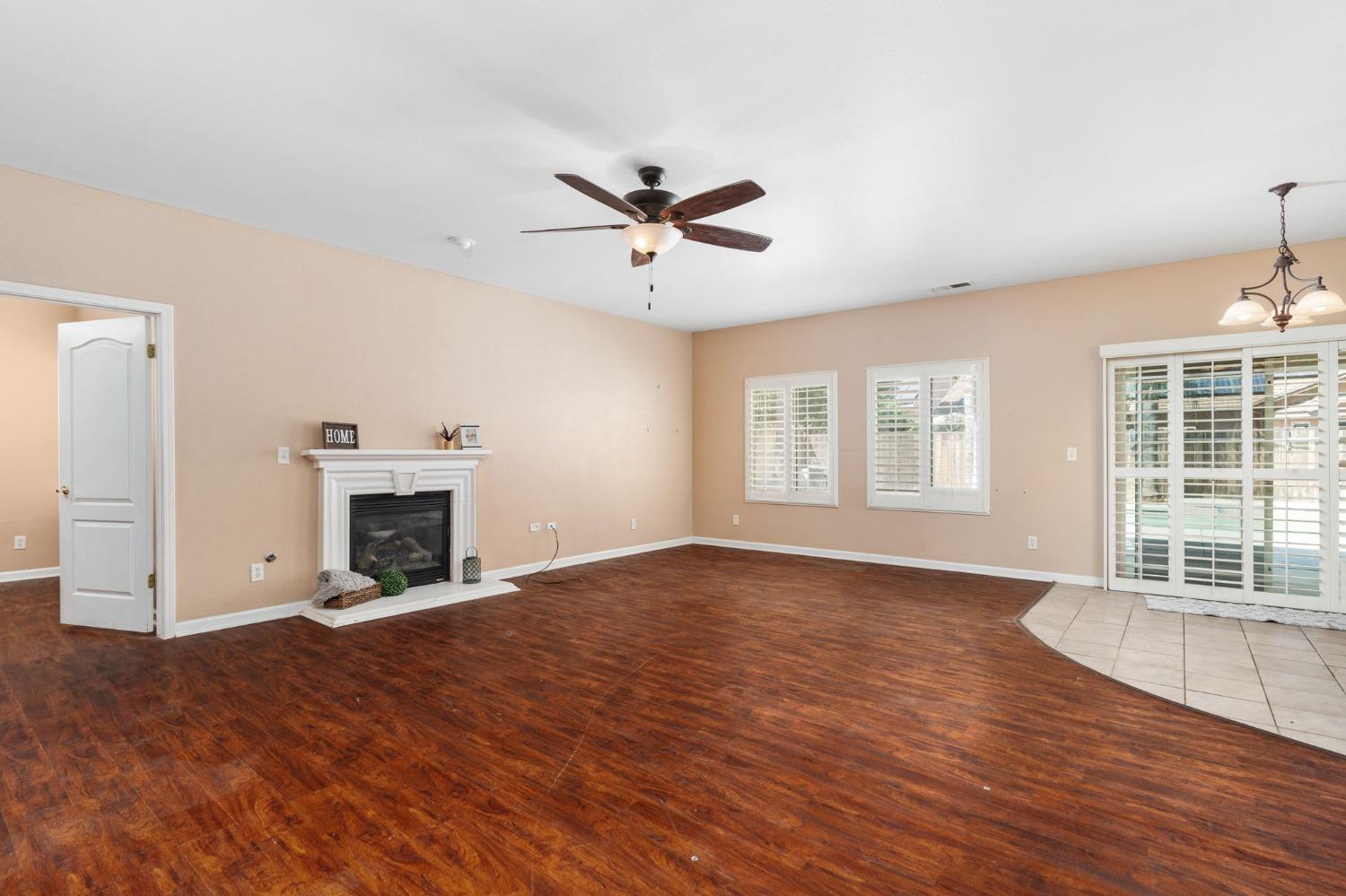 2763 Pico Avenue Clovis, CA 93611 - Photo 15 of 27 an empty room with windows fireplace and a wooden floor
