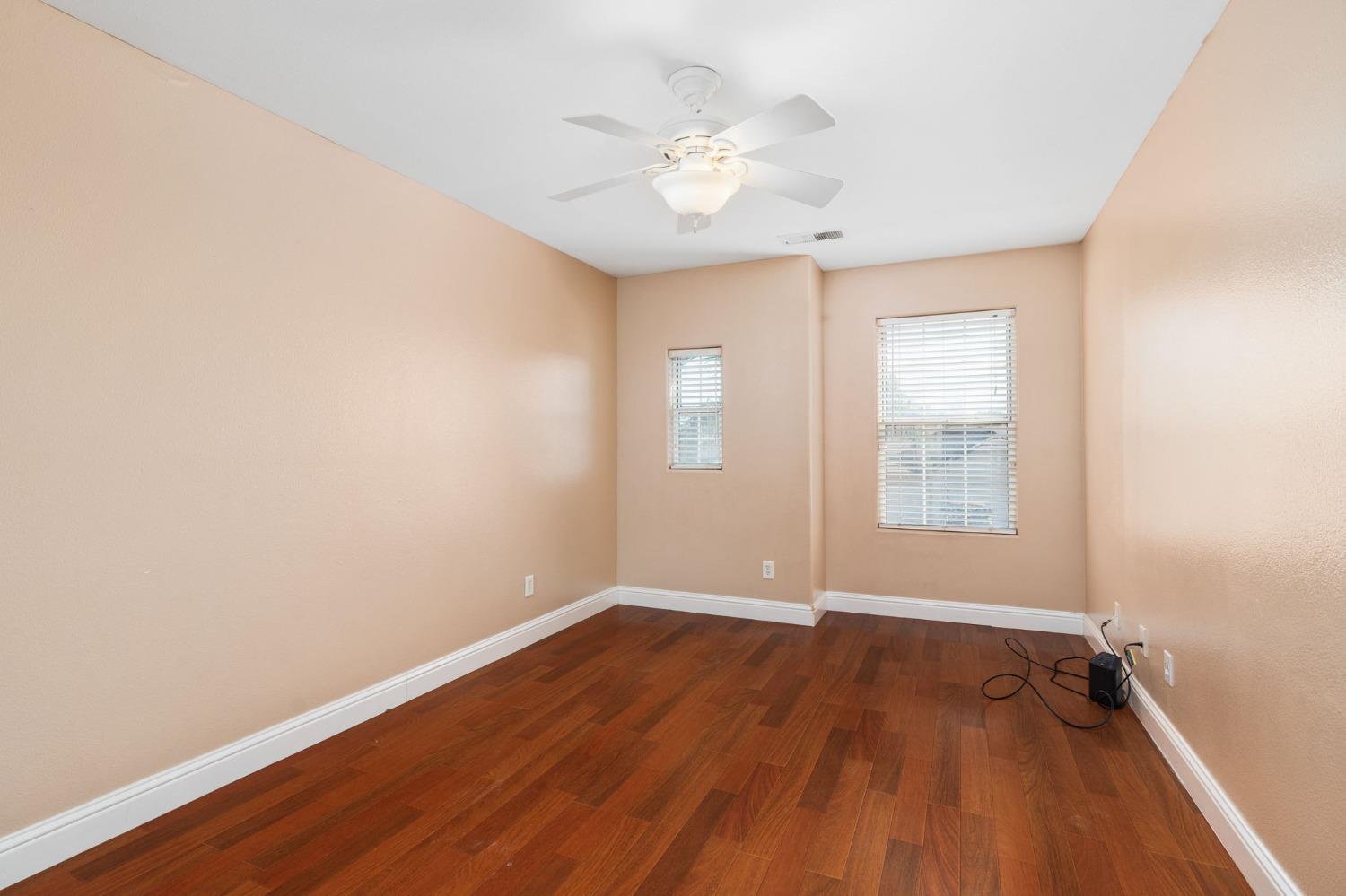 2763 Pico Avenue Clovis, CA 93611 - Photo 20 of 27 an empty room with wooden floor and windows