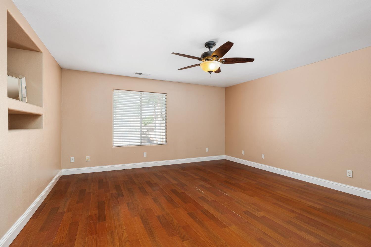 2763 Pico Avenue Clovis, CA 93611 - Photo 22 of 27 a view of an empty room with a window and wooden floor