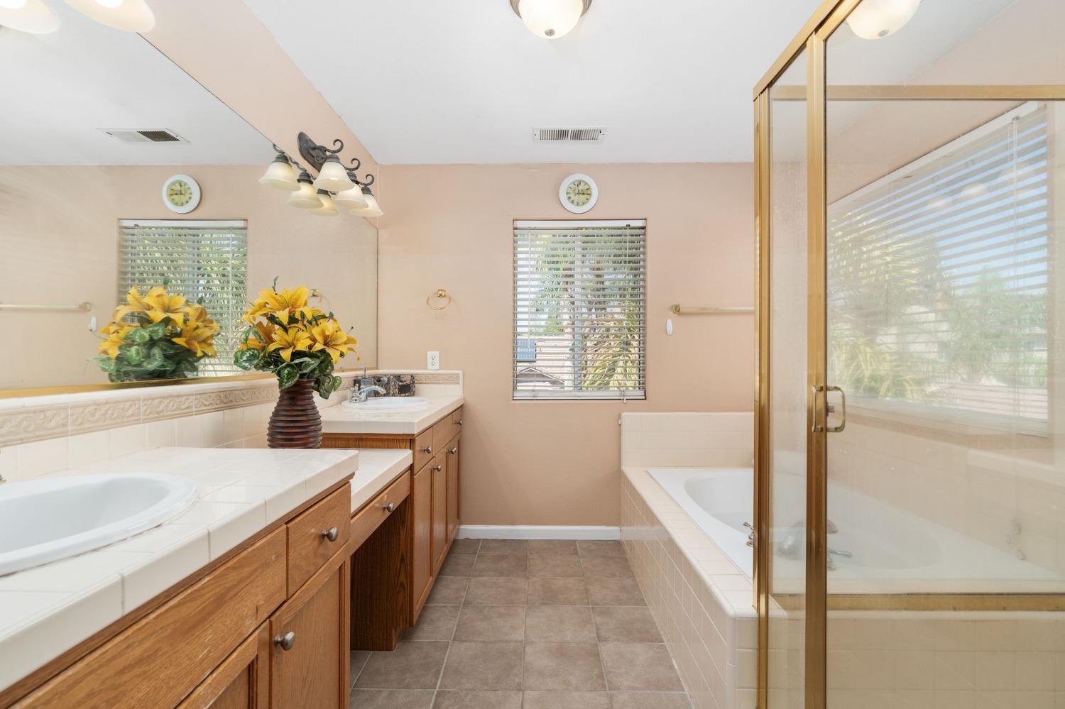 2763 Pico Avenue Clovis, CA 93611 - Photo 23 of 27 a bathroom with a tub sink and mirror