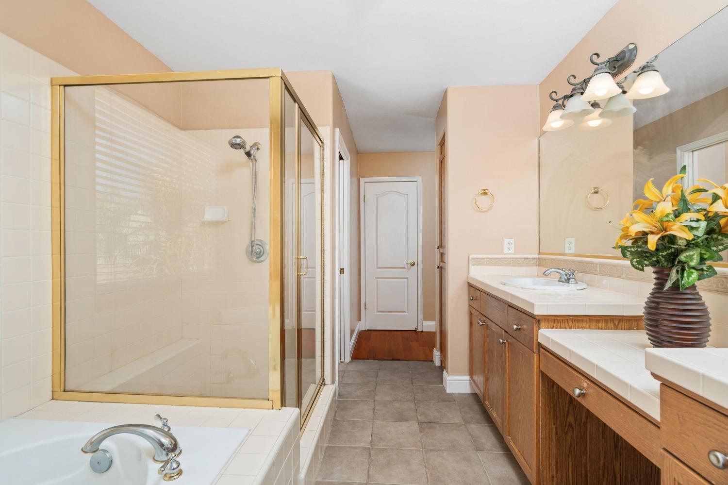 2763 Pico Avenue Clovis, CA 93611 - Photo 24 of 27 a bathroom with a granite countertop sink a mirror and a shower