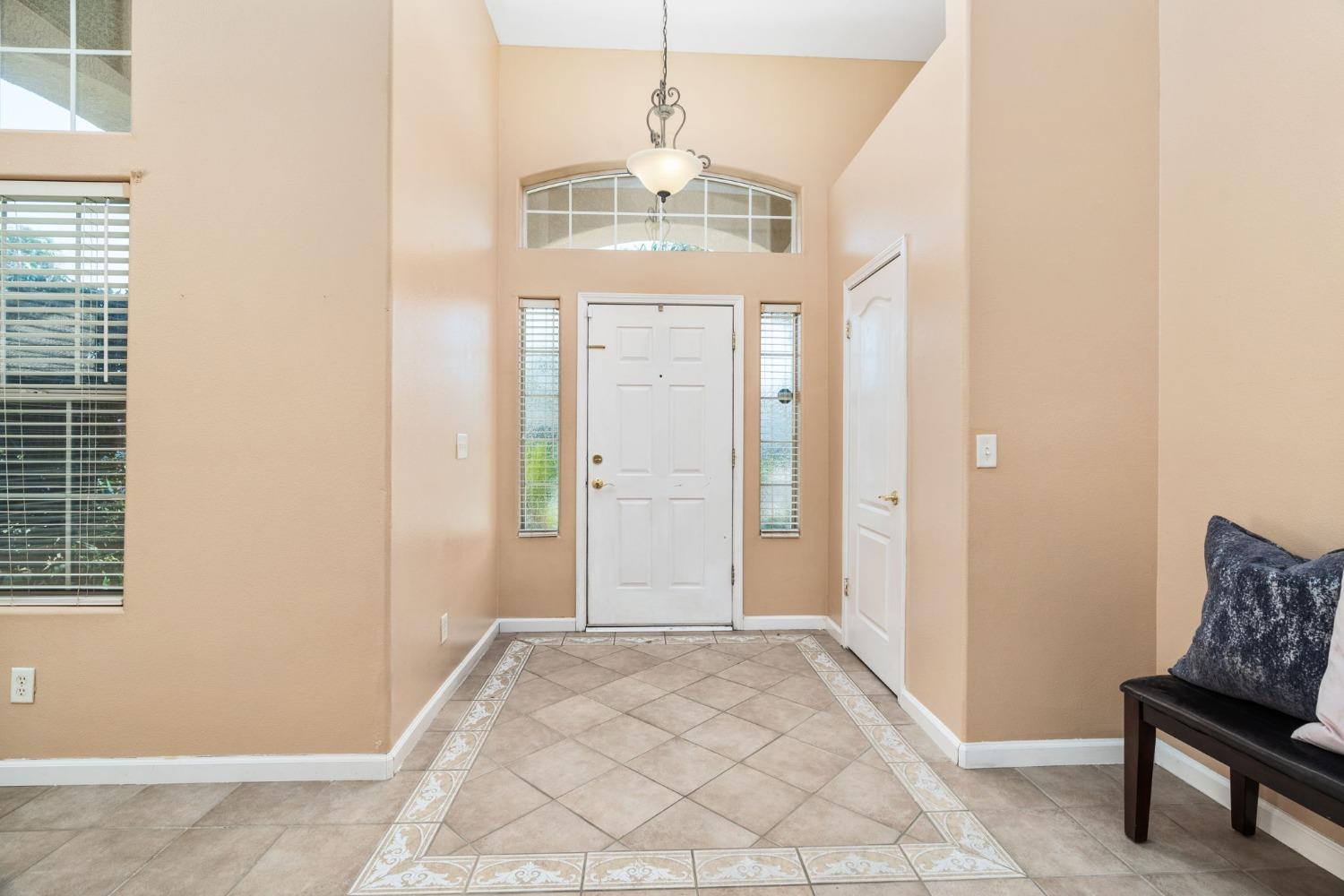 2763 Pico Avenue Clovis, CA 93611 - Photo 6 of 27 a view of a hallway with windows and chandelier