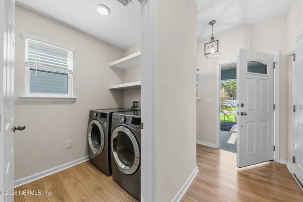 a view of a hallway with washer and dryer