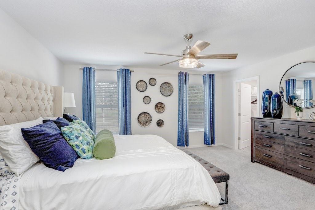 5349 Coldpine Place Seffner, FL 33584 - Photo 15 of 24 a large bedroom with a bed and a chandelier