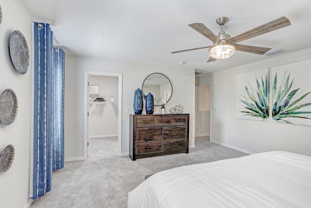 5349 Coldpine Place Seffner, FL 33584 - Photo 16 of 24 a bedroom with a bed and a chandelier