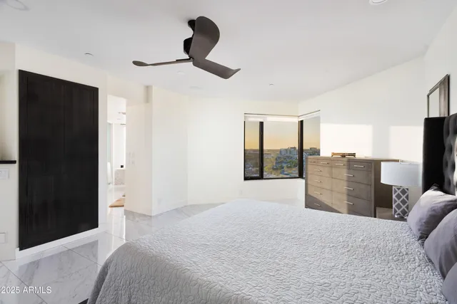 a bedroom with a bed and a television