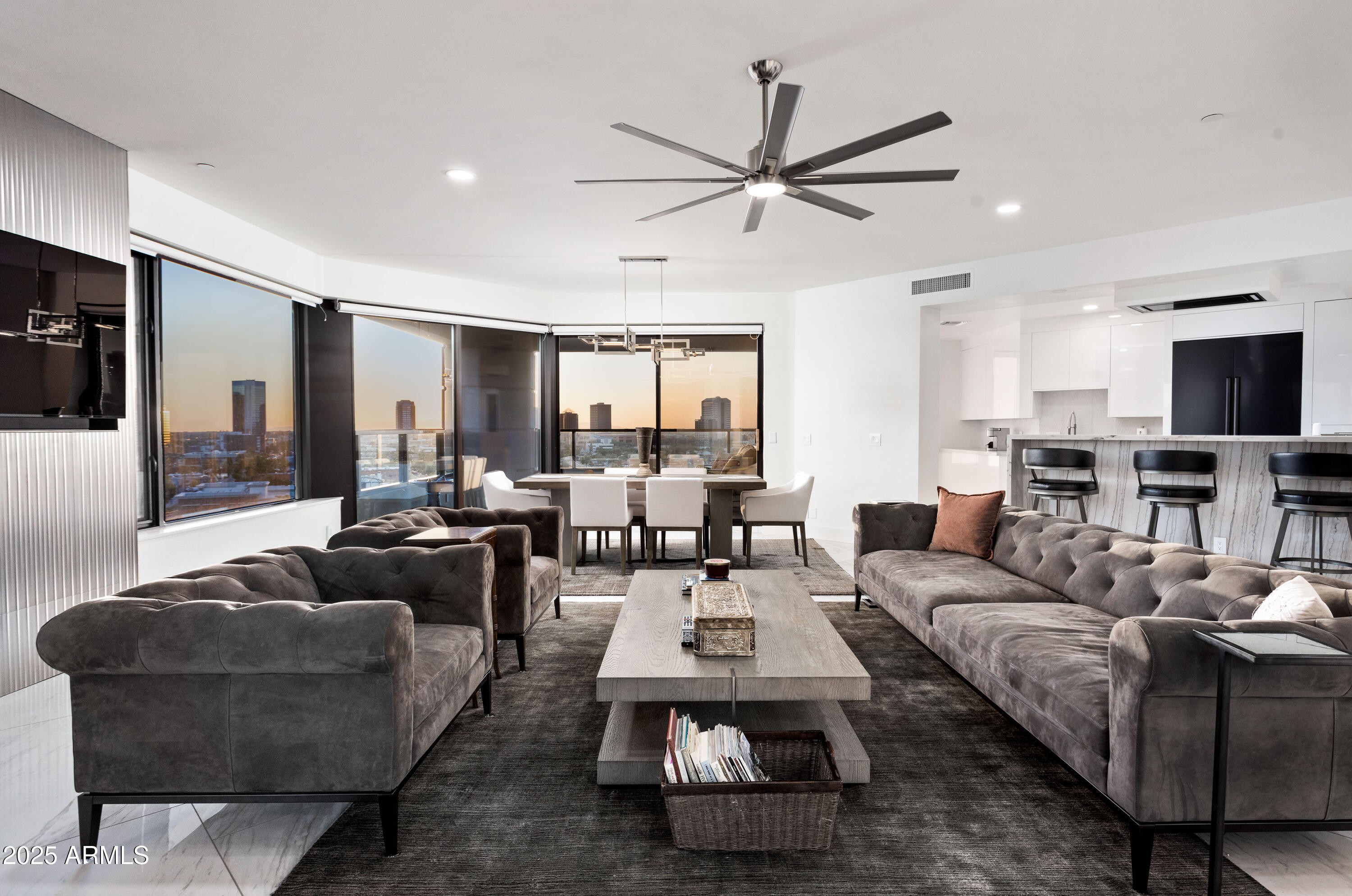 1040 East Osborn Road, Unit 904 Phoenix, AZ 85014 - Photo 3 of 22 a living room with furniture a flat screen tv and a window