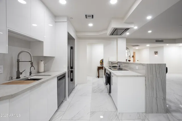 a kitchen with stainless steel appliances granite countertop a sink and cabinets
