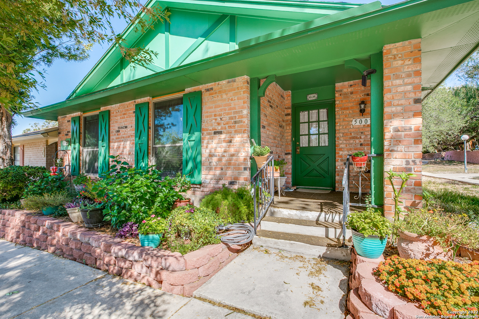 a front view of a house with garden