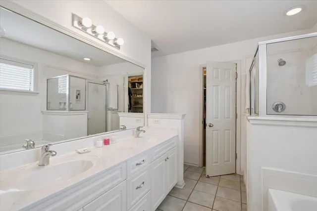 a spacious bathroom with a double vanity sink mirror and double