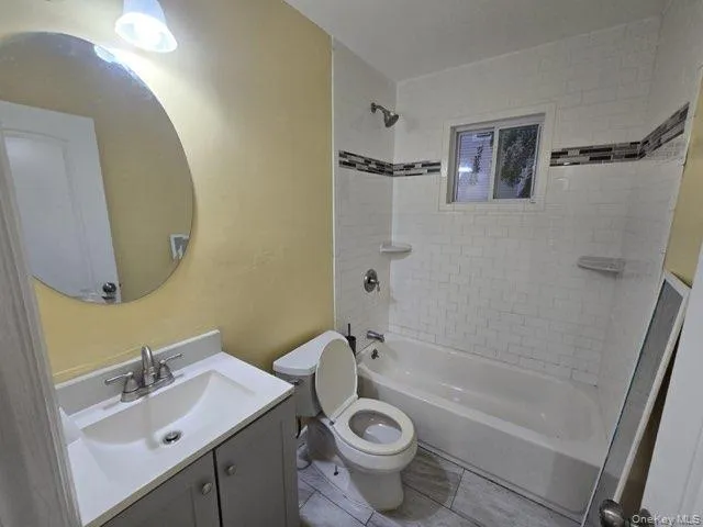 a bathroom with a sink toilet a mirror and shower