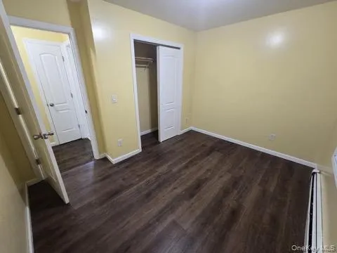 an empty room with wooden floor and a window