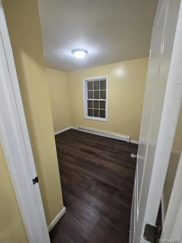 a view of wooden floor and windows in a room