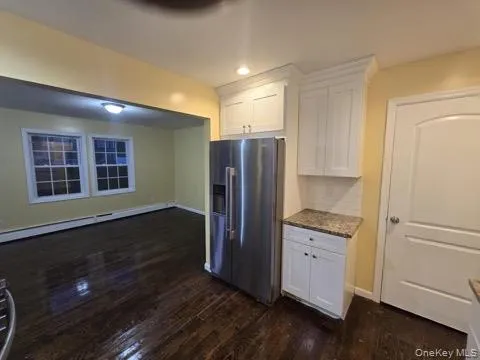 a view of kitchen with wooden floor and electronic appliances