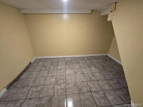 a view of a room with an empty space and a window