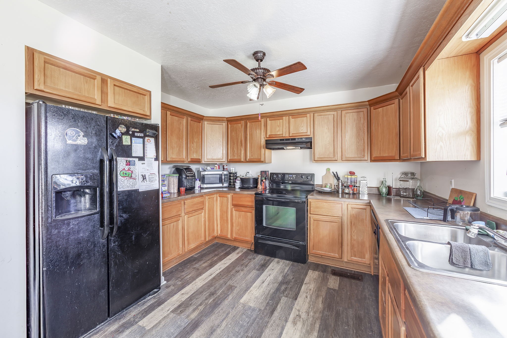 42 Jesse Patterson Road Trenton, TN 38382 - Photo 11 of 27 a kitchen with stainless steel appliances granite countertop a refrigerator a sink dishwasher a stove and white countertops with wooden floor