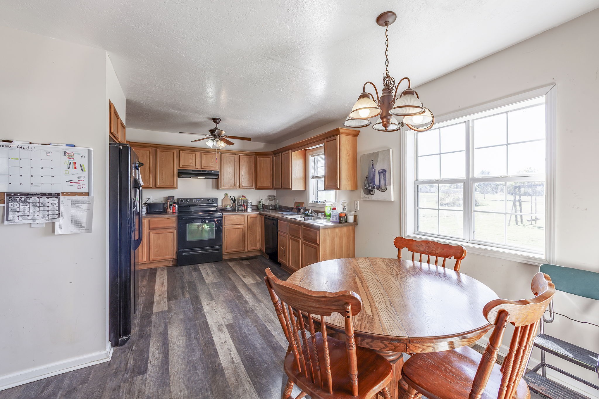 42 Jesse Patterson Road Trenton, TN 38382 - Photo 13 of 27 a open dining room with stainless steel appliances kitchen island granite countertop a table chairs and a chandelier
